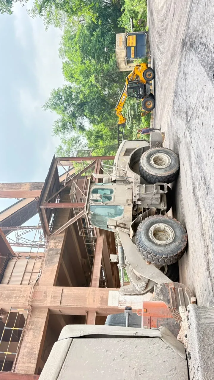 Heavy vehicle beside an industrial structure