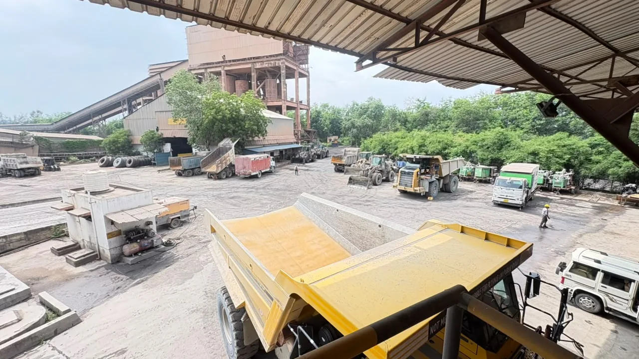 Industrial project yard with vehicles and plant structures